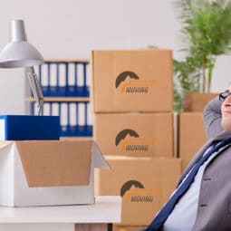It shows an office worker who is thinking on how to choose the best commercial moving company in Calgary
