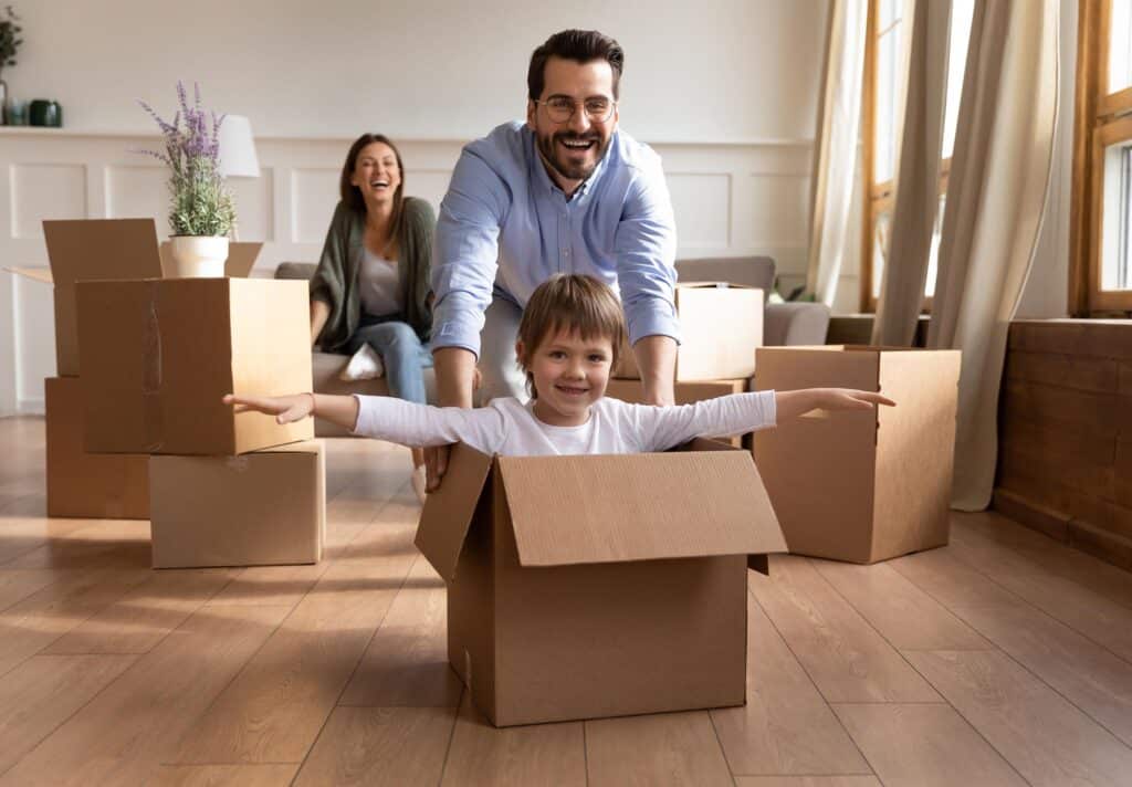Parents having great time packing and moving with children 