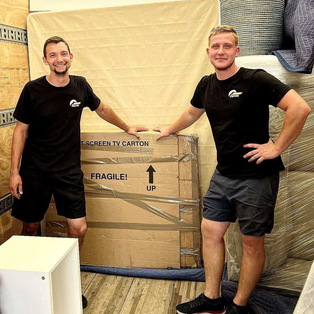Professional movers carefully packing boxes for Calgary to Brandon move